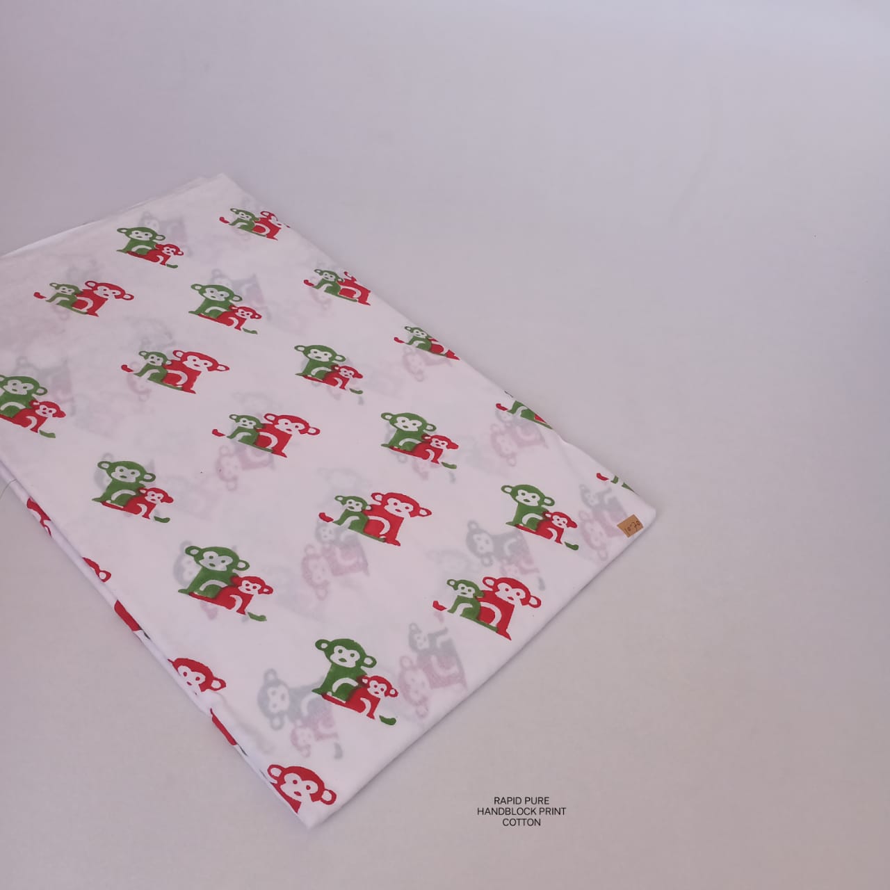 Wholesale Jaipur Sanganeri Handblock Cotton Fabric in white and red featuring monkey butti print, perfect for B2B bulk sourcing.